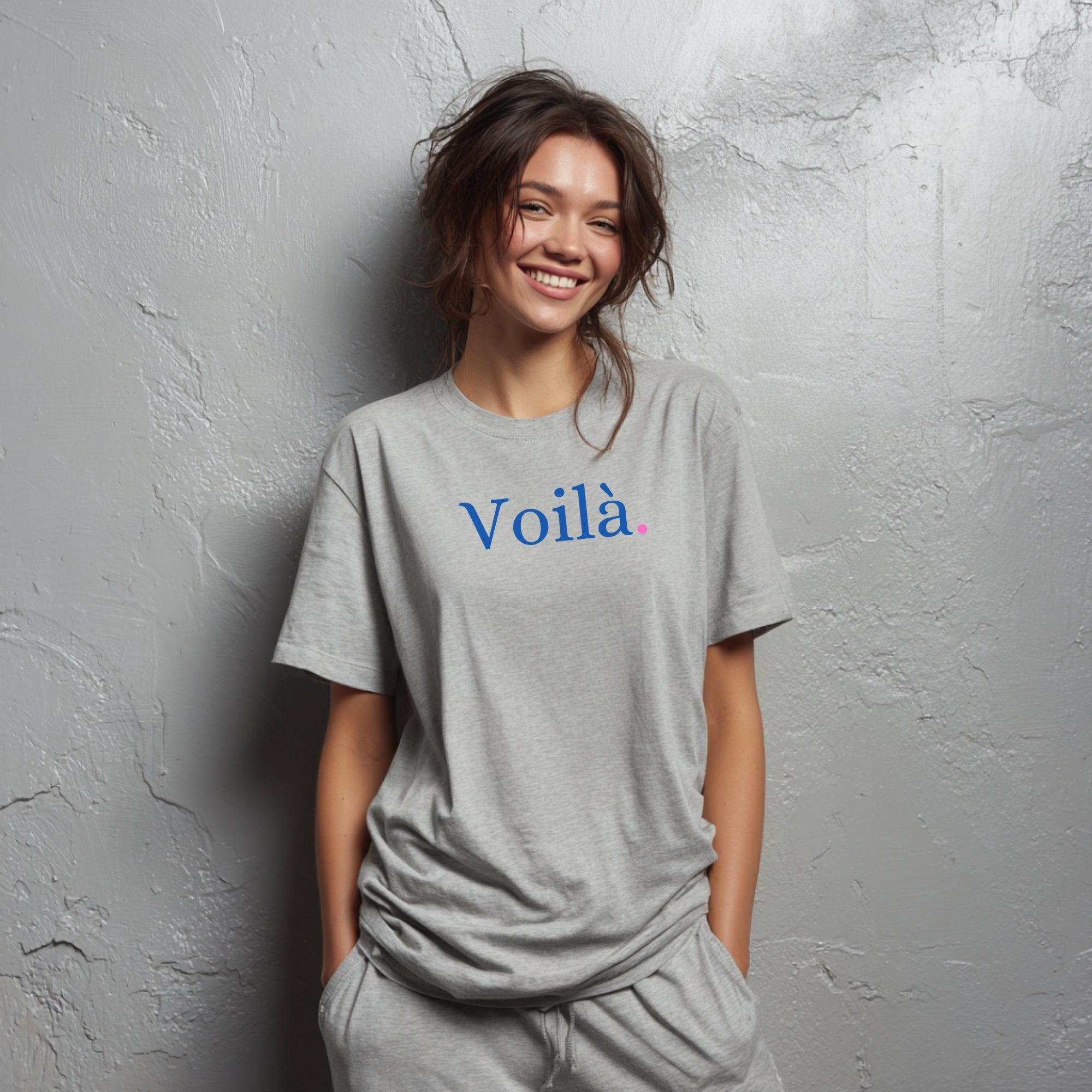 Modell trägt hellgraues T-Shirt mit dezentem „Voilà“-Aufdruck im französischen Stil
